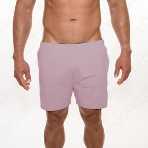 A guy wearing pale pink shorts, showing from the waist to the thighs, exhibiting bulge enhancement with a visible muscular torso and arms, against a white background.