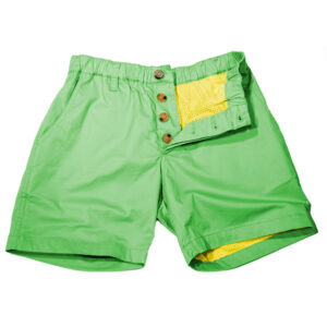 A pair of bright green shorts with a yellow pocket and trim, featuring wooden button details and bulge enhancement, displayed on a white background.