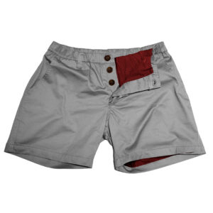 WOOF Freeball Chinos™ "Solid Pines" shorts with a red pocket liner and wooden button details, isolated on a white background, available for pre-order.